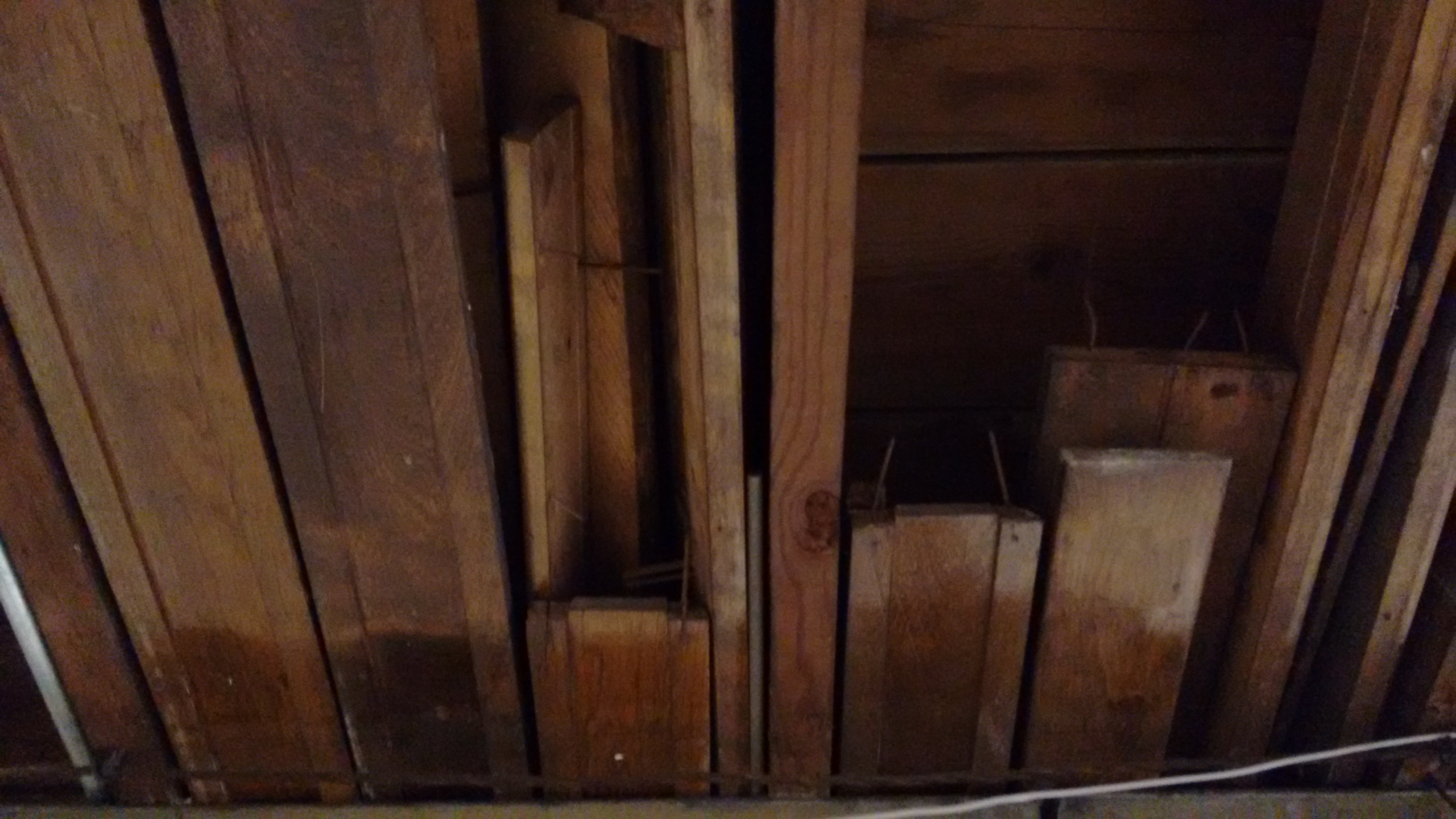 Trim that is stored in the floor joists of the bungalow in the basement.